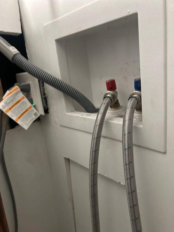 Relocated gas and water supply lines to accommodate new washer and dryer placement. Installed recessed washing machine outlet box with hot and cold water connections using braided stainless steel flexible supply lines. Rerouted gas line using yellow corrugated flexible conduit and coordinated electrical conduit placement to ensure proper clearances and code compliance for the laundry appliance installation.