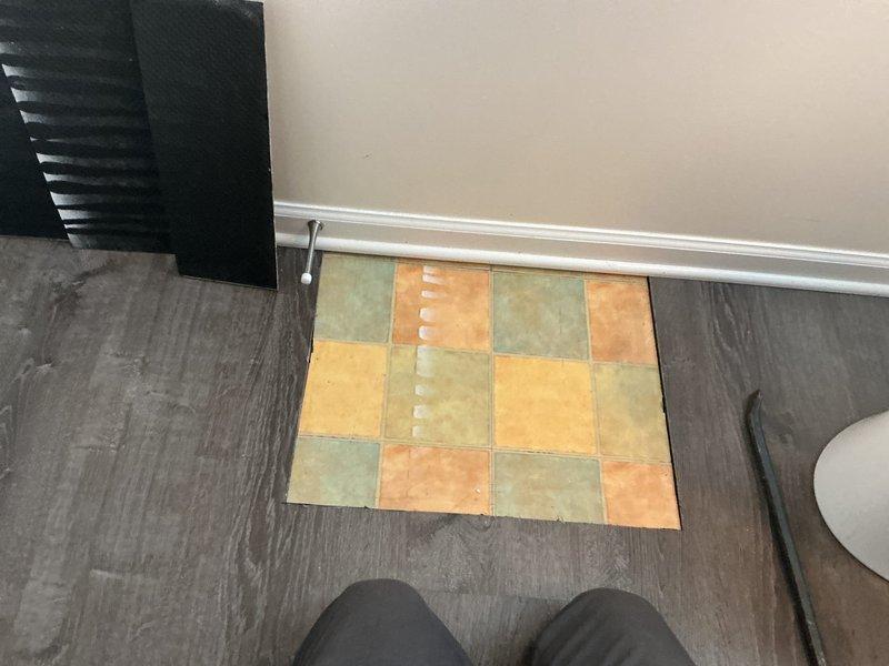 Collected down payment for approved plumbing repair work involving subfloor access and flooring removal. Documented existing conditions showing compromised subfloor area with debris and damaged underlayment requiring excavation and remediation before plumbing repairs can proceed.