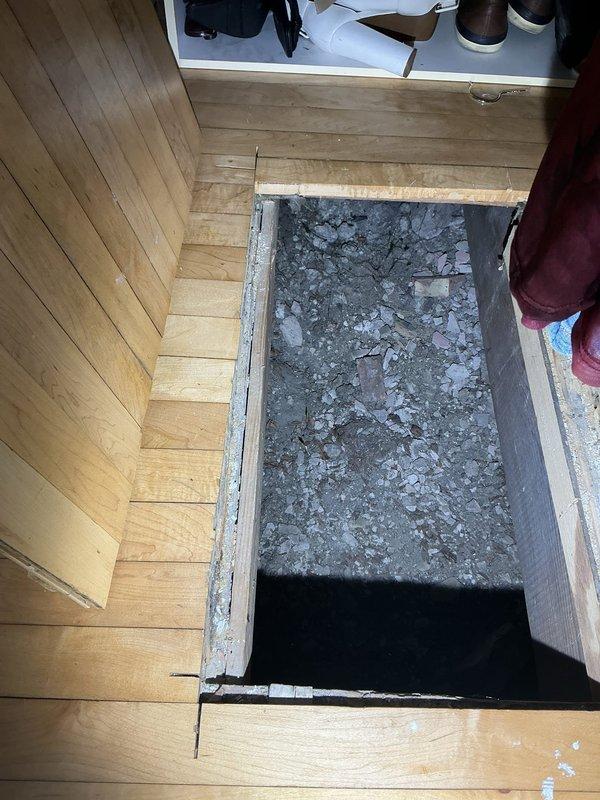 Collected down payment for approved plumbing repair work involving subfloor access and flooring removal. Documented existing conditions showing compromised subfloor area with debris and damaged underlayment requiring excavation and remediation before plumbing repairs can proceed.