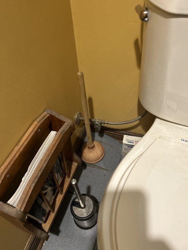 Responded to emergency water leak originating from upstairs bathroom sink, which was penetrating through ceiling fixtures and flooding the kitchen below. Inspected the temporarily taped sink connection and underlying plumbing infrastructure, documenting corroded pipe fittings and compromised seals causing the active leak. Additionally assessed downstairs bathroom for reported sewer odor and examined disassembled toilet components to determine serviceability and identify necessary repairs for proper reinstallation and function.
