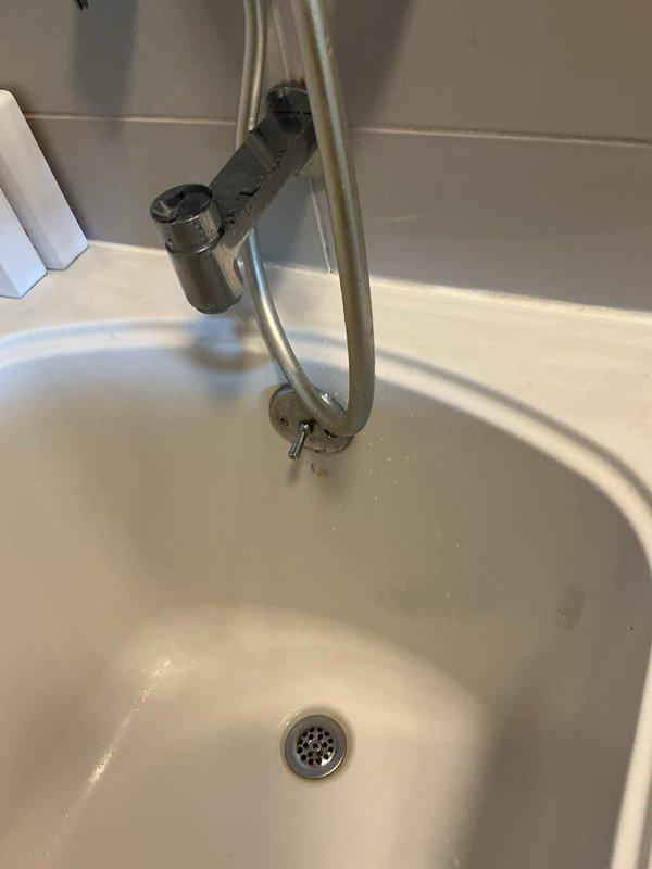 Responded to reported leak from bathroom to unit below. Inspected bathtub drain assembly and overflow system, replaced deteriorated drain seal and overflow gasket to eliminate water penetration. Tested valve connections for leakage and confirmed proper operation. Removed old caulking around bathtub perimeter and applied fresh silicone sealant to prevent water intrusion. Conducted water flow test to verify repairs resolved leak issue.