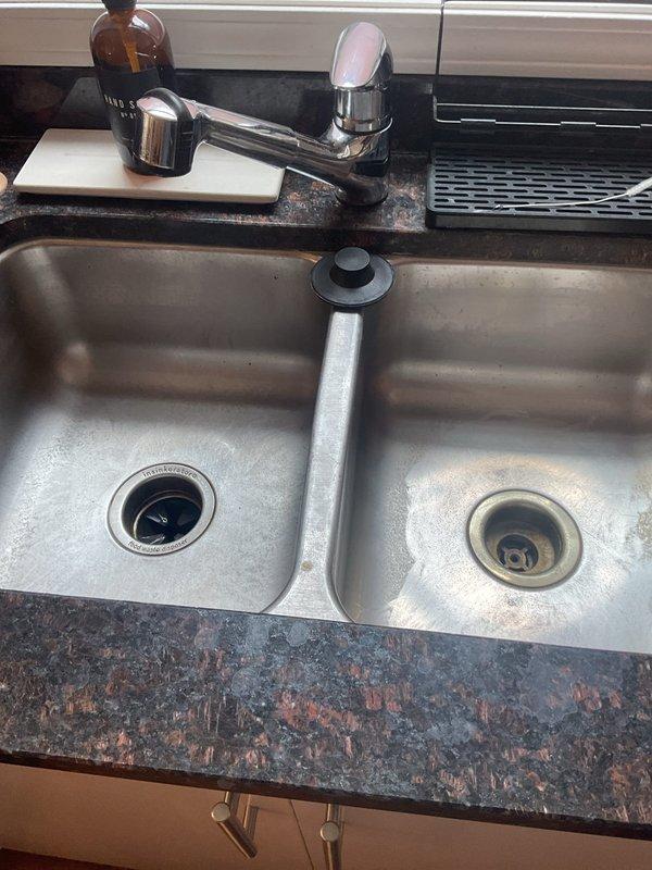 Responded to service call for recurring kitchen sink drainage issues in double-basin stainless steel sink. Customer reported clogging problems resuming one week prior, despite mini hydro jet treatment performed in January. Conducted thorough diagnostic inspection of drain system to identify root cause of persistent blockages. Assessed both sink basins, drain assemblies, and visible plumbing connections to determine nature and location of obstruction affecting proper water flow.