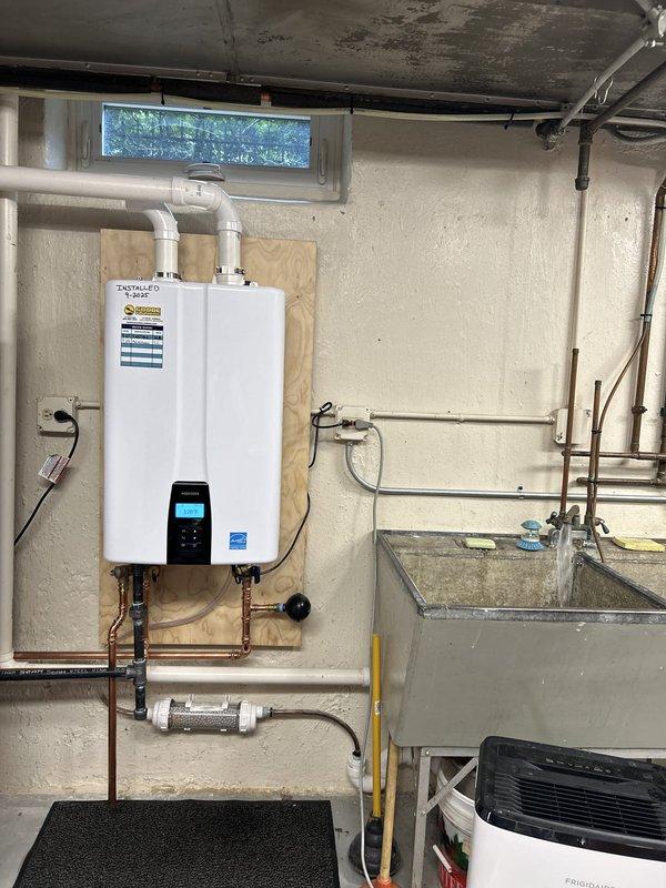 Performed annual maintenance service on residential tankless water heater, completing the first scheduled maintenance since initial installation. Flushed the tankless water heater system to remove mineral deposits and sediment buildup, inspected and cleaned the inlet filter screen which showed moderate accumulation of debris, and verified proper operation of all components including gas connections, copper water lines, pressure relief valve, and venting system. Unit tested successfully with normal operating parameters restored.