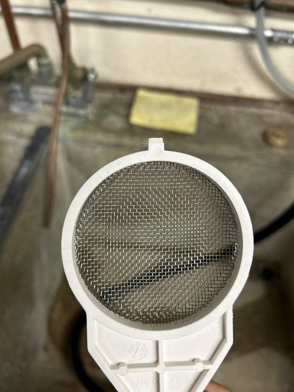 Performed annual maintenance service on residential tankless water heater, completing the first scheduled maintenance since initial installation. Flushed the tankless water heater system to remove mineral deposits and sediment buildup, inspected and cleaned the inlet filter screen which showed moderate accumulation of debris, and verified proper operation of all components including gas connections, copper water lines, pressure relief valve, and venting system. Unit tested successfully with normal operating parameters restored.