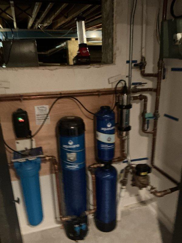 Completed annual maintenance inspection on residential water treatment system and sump pump basin. Inspected multi-tank water filtration and softening system including all copper piping connections, valves, and electrical control unit for proper operation. Descended into sump pump pit to perform thorough inspection and maintenance of pump equipment, checking for proper function, debris accumulation, and component wear. Verified all plumbing connections, discharge piping, and mechanical components are operating within normal parameters.