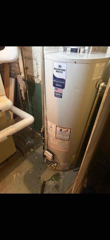 Responded to service request for hot water heater evaluation. Upon inspection, completed installation of a 50-gallon Bradford White tanked water heater in the basement utility area with proper copper piping connections and code-compliant installation. Customer indicated unit may be under manufacturer warranty for future reference.