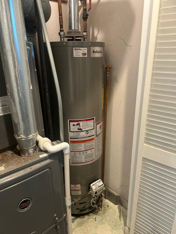 Responded to service call for inadequate heating on residential tank-style water heater. Upon arrival, inspected Bradford White/Reliance brand water heater approximately five to ten years old located in utility closet alongside HVAC equipment. Conducted diagnostic assessment of heating performance and examined all visible components including copper supply lines, temperature and pressure relief valve connections, and gas control valve assembly. Verified proper plumbing connections and checked for any signs of sediment buildup or mechanical failure affecting heating capacity. Documented equipment condition with photographs showing unit specifications, manufacturer labels, and installation configuration. Provided customer with findings and recommended service options to restore optimal water heating performance.