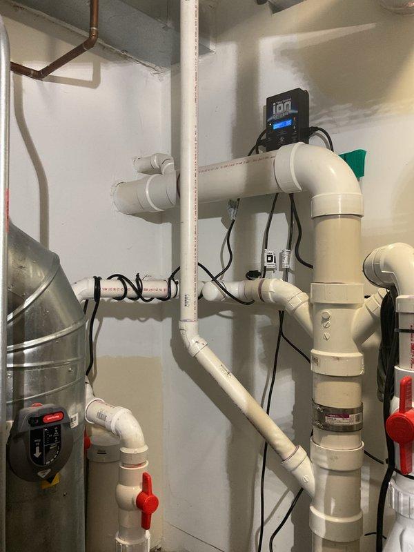 Responded to service call for sump pump making loud noise. Upon inspection, tested electrical components with digital multimeter and confirmed proper voltage at 24.85V to control circuit. Inspected PVC drainage piping system, drain pan assembly, and associated plumbing connections for proper operation and secure mounting. Verified all pipe joints, fittings, and discharge lines were properly configured with no obstructions or drainage issues that could cause operational noise. System tested and returned to normal operation.