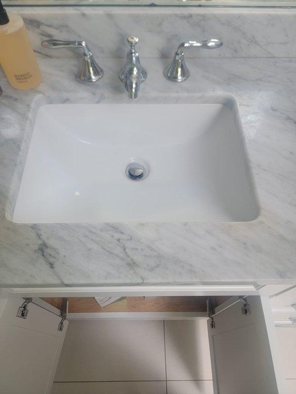 Responded to service call for multiple plumbing concerns including slow-draining bathroom sink, recurring residue rings in toilet, and persistent film buildup in sink and toilet fixtures. Performed thorough drain cleaning of bathroom vanity sink with undermount basin and chrome three-handle faucet assembly. Cleared blockage and restored proper drainage flow. Inspected all affected fixtures for biofilm accumulation and mineral deposits contributing to visible residue issues.

Conducted comprehensive inspection of Navien tankless water heater following reported malfunction where unit failed to produce hot water for approximately 30 minutes three days prior to service visit. Examined unit for error codes, tested ignition sequence, verified gas supply and pressure, checked water flow sensors, and assessed heat exchanger for scale buildup or blockages. Confirmed proper venting and combustion air supply. Tested unit operation through multiple hot water demand cycles to verify restoration of 