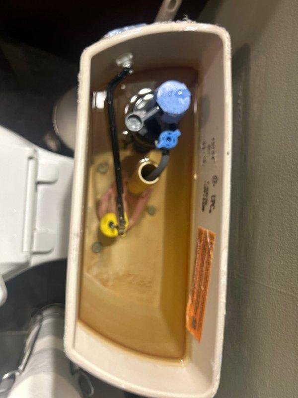 Responded to service call for multiple plumbing issues including leaking garbage disposal, bathroom faucet handle replacement, and continuously running toilet. Inspected kitchen sink cabinet and identified leak source at garbage disposal mounting flange and drain connections. Tightened mounting assembly and verified proper seal at sink connection. Replaced worn bathroom faucet handle with new fixture hardware. Diagnosed running toilet by accessing internal tank components through wall-mounted access panel, adjusted fill valve and flapper mechanism to restore proper water shutoff function. Tested all repaired fixtures for proper operation and confirmed no active leaks present upon completion.