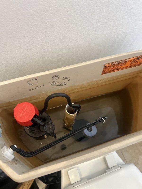 Responded to service call for toilet tank that would not fill and could not retain water when manually filled. Upon inspection, found faulty fill valve assembly and compromised flush valve causing water to continuously leak from tank into bowl. Removed and replaced defective fill valve with new assembly, adjusted float mechanism to proper water level, and installed new flapper seal on flush valve to prevent tank drainage. Tested system operation multiple times to confirm proper filling cycle, verified tank maintains water level, and ensured complete flush function. Tank now fills automatically and maintains proper water level without leakage.