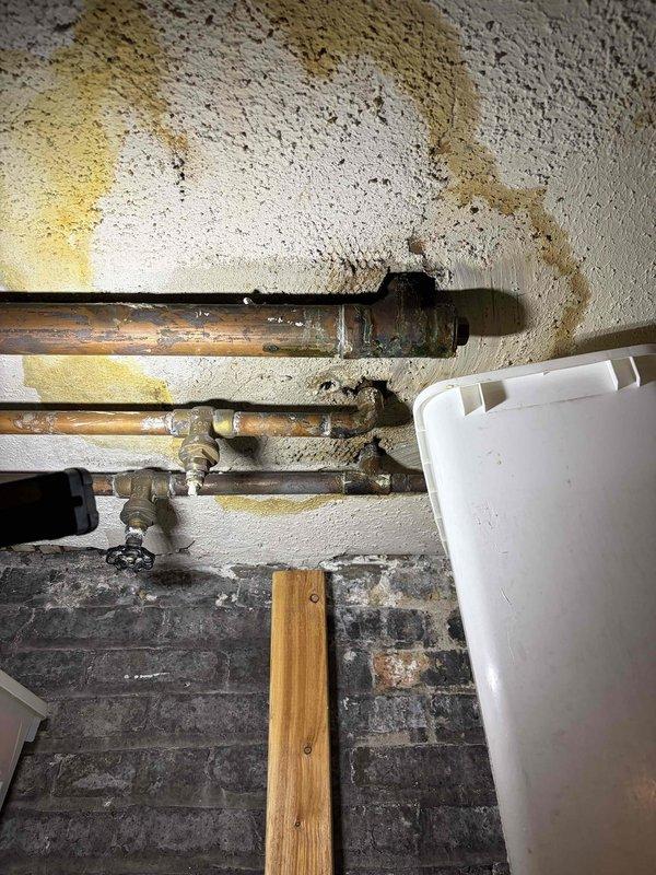 Responded to emergency same-day service call for active water leak in basement affecting storage area. Upon inspection, identified compromised copper piping system with visible corrosion, oxidation, and patina buildup on multiple pipe sections and joints. Located leak source at deteriorated pipe fittings in the overhead distribution system. Performed immediate leak isolation and repairs to affected pipe sections and connections. Replaced corroded fittings and compromised joints to restore system integrity and prevent further water intrusion into storage unit.
