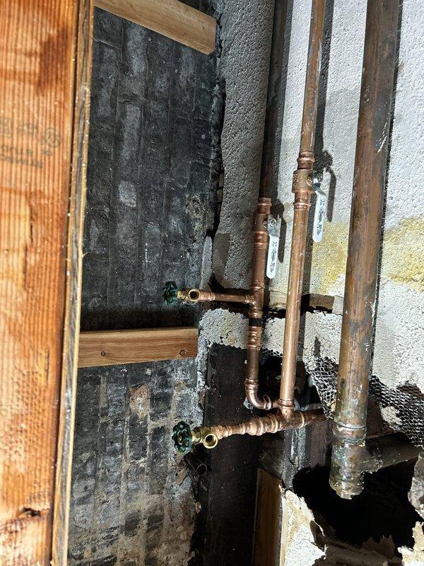 Responded to emergency same-day service call for active water leak in basement affecting storage area. Upon inspection, identified compromised copper piping system with visible corrosion, oxidation, and patina buildup on multiple pipe sections and joints. Located leak source at deteriorated pipe fittings in the overhead distribution system. Performed immediate leak isolation and repairs to affected pipe sections and connections. Replaced corroded fittings and compromised joints to restore system integrity and prevent further water intrusion into storage unit.