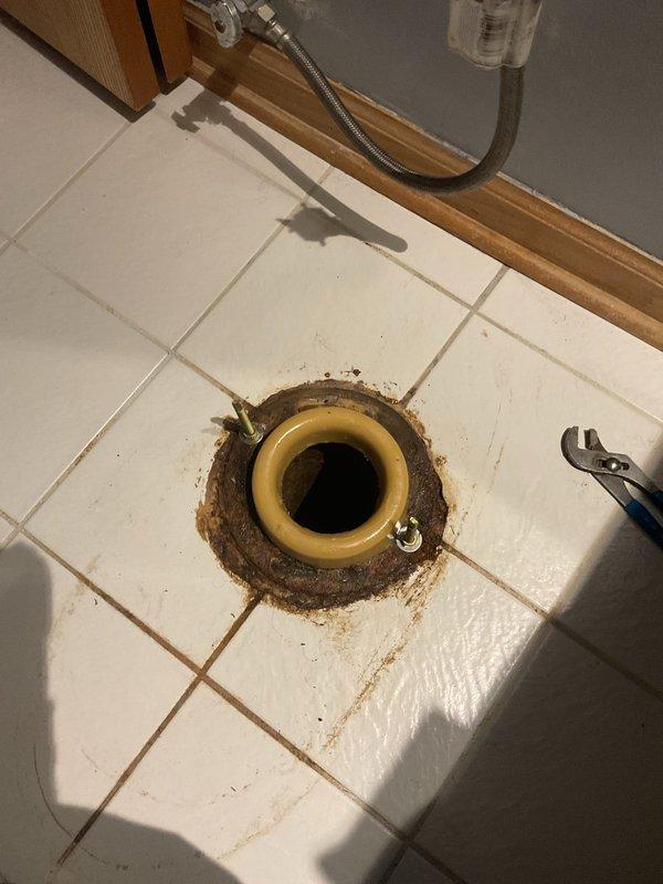 Responded to service call for toilet leaking at base. Removed toilet to access flange and discovered deteriorated wax ring seal causing water seepage onto bathroom floor. Cleaned flange area, removed old wax ring and debris buildup, inspected flange bolts for integrity, and installed new wax ring seal. Reset toilet onto flange, secured with existing bolts, reconnected water supply line, and tested for proper seal and operation with no leaks detected.