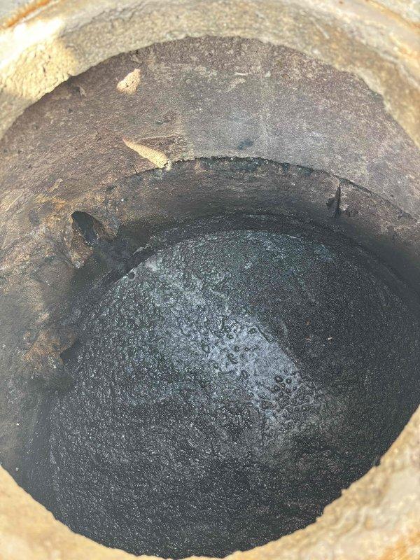Responded to commercial facility for clogged drain system. Upon inspection, discovered severely corroded pump bearing and mounting flange causing drainage failure. Removed heavily deteriorated components exhibiting extensive rust damage and mineral buildup. The existing flange showed significant corrosion around the central opening with substantial debris accumulation in the drain cavity. Replaced failed bearing assembly and corroded mounting hardware with new components. Cleared thick oily sludge and black residue from drain access point. Restored proper drainage function and tested system operation to ensure complete resolution.