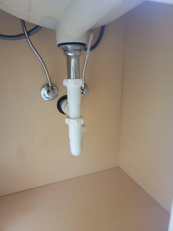 Responded to multiple plumbing issues including clogged drains and toilet repairs. Removed toilet tank lid and inspected flush valve mechanism and fill valve assembly, confirming proper operation of flapper seal and internal components. Addressed clogged toilet by clearing obstruction and verifying proper drainage and flush function. Tightened loose shower faucet to eliminate movement and ensure proper mounting. Inspected under-sink P-trap assembly and drain lines for blockages, confirming clear flow through PVC drainage system. Examined basement water supply line for potential clogs or routing concerns, verified proper water flow and pressure throughout the system. All fixtures tested and returned to normal operation upon completion.