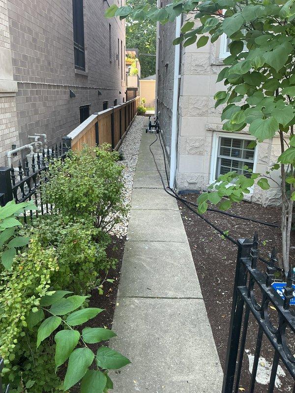 Responded to reports of intermittent sewage odor at exterior of six-unit building and recent basement water line backup. Conducted site inspection of building perimeter, focusing on waste pump system and drainage infrastructure. Examined exterior foundation areas, utility access points, and grade conditions around building where odor was reported, particularly areas prone to water accumulation during rain events. Documented existing conditions including exterior wall construction, ground-level utilities, and landscaping drainage patterns. Assessed potential sources of sewage smell including waste pump discharge lines, vent system integrity, and possible subsurface drainage issues. Evaluated correlation between reported odor occurrences and rainfall, suggesting potential groundwater infiltration or compromised waste pump discharge piping. Photographed critical areas for estimate preparation and recommended further diagnostic work to identify specific failure points in waste pump system 
