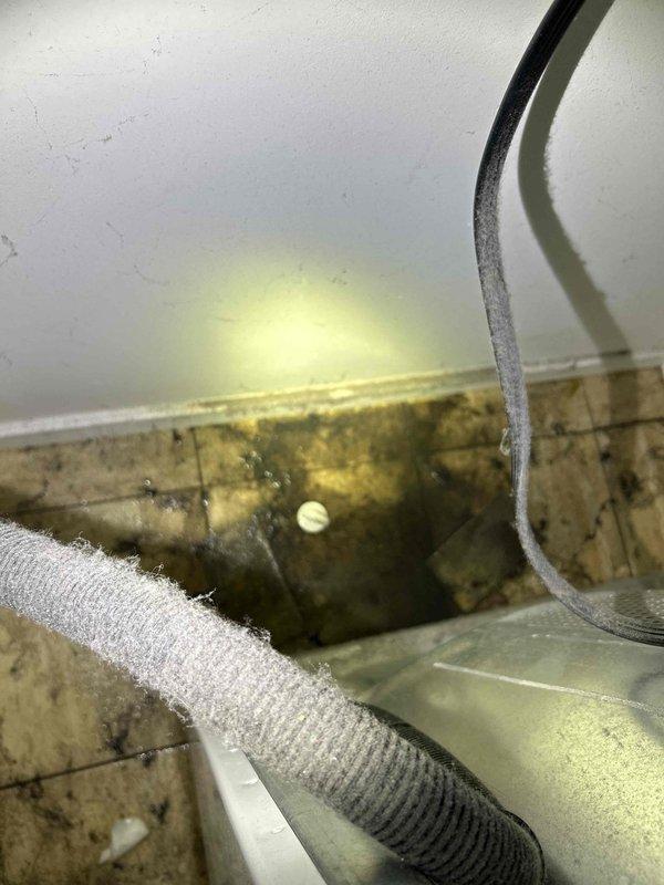Contacted customer to provide detailed documentation for their previous two service appointments. Documented HVAC system conditions including refrigerant line insulation status, air handler interior compartment with visible mold and mildew growth on surfaces due to condensation accumulation, and condensate drainage components. Photographed affected areas showing biological contamination on wooden surfaces within the unit, insulated refrigerant lines, electrical conduit routing, and ceiling access points to provide comprehensive visual records for invoice clarification purposes.