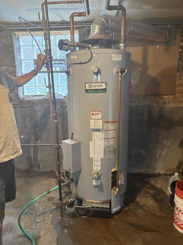 Completed installation of A.O. Smith water heater in residential basement with full copper piping connections to existing plumbing system. Installed all necessary fittings, valves, and overhead pipe connections, ensuring proper integration with home's water distribution network. Customer will remit remaining balance via check upon completion.