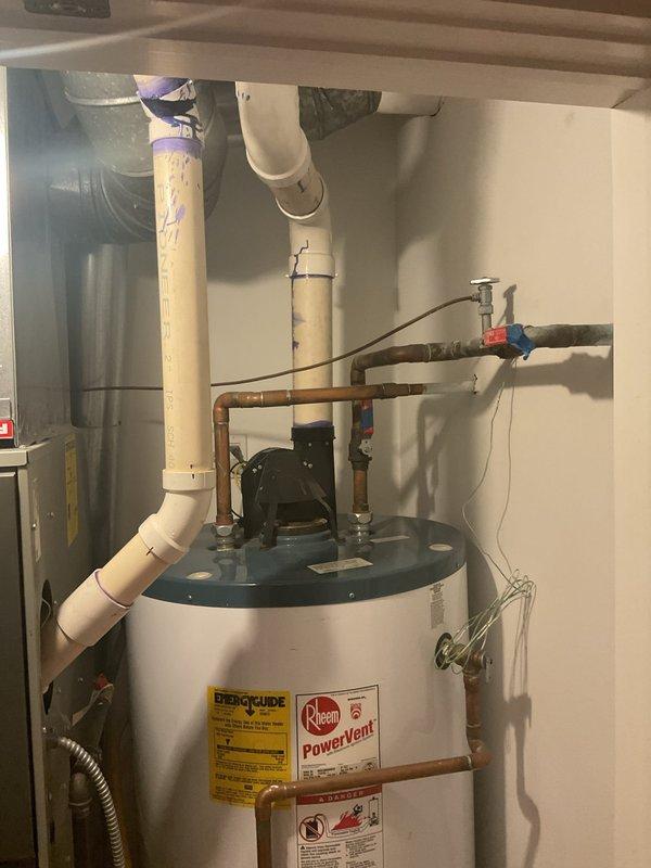 Conducted on-site assessment of existing Rheem 75-gallon, 75,000 BTU natural gas power vent water heater in condo unit for replacement estimate. Documented current installation configuration including copper supply lines, PVC venting system, temperature and pressure relief valve piping, shut-off valves, and power vent motor assembly. Photographed all plumbing connections, gas line routing, condensate drainage, and clearance dimensions to provide accurate quote for comparable Rheem model replacement with similar specifications and power vent configuration.