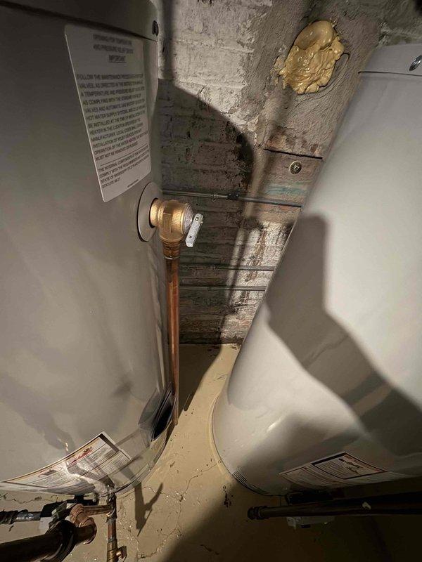 Completed installation of two 50-gallon water heaters in basement utility space with full copper piping connections and brass fittings. All units were properly positioned, plumbed with vertical supply lines, and connected to existing infrastructure per manufacturer specifications and local plumbing codes.