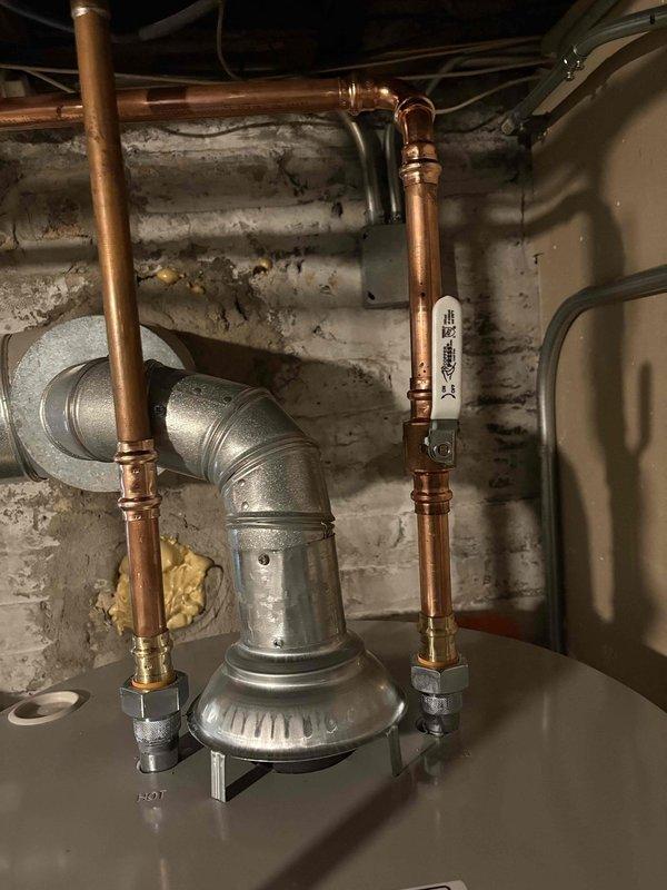 Completed installation of two 50-gallon water heaters in basement utility space with full copper piping connections and brass fittings. All units were properly positioned, plumbed with vertical supply lines, and connected to existing infrastructure per manufacturer specifications and local plumbing codes.