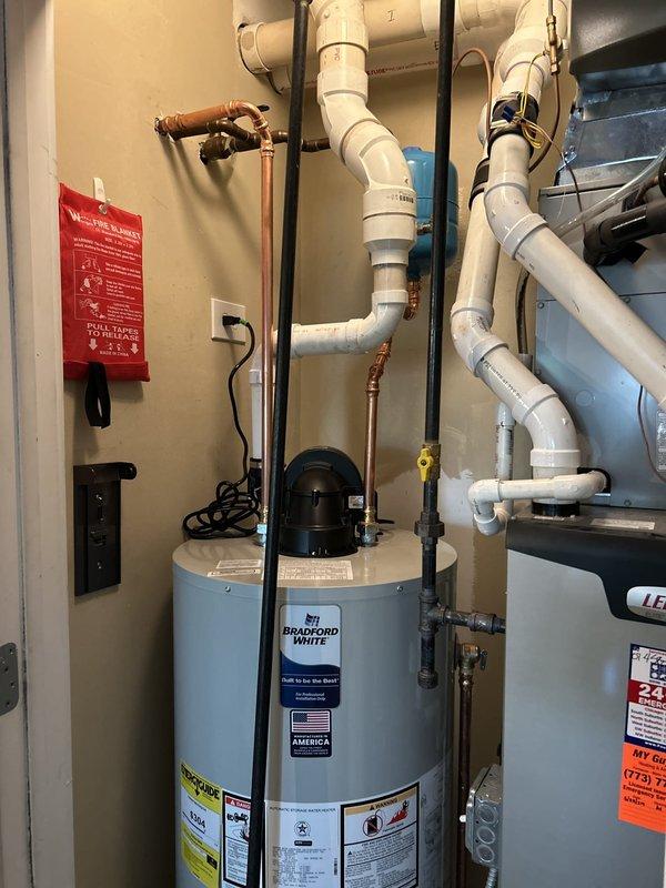 Replaced existing 50-gallon water heater with new Bradford White power vent unit, including installation of expansion tank and upgraded brass drain valve. Configured all necessary connections, plumbing lines, and PVC venting system with proper supports and code-compliant installation. Removed and hauled away old water heater from premises, leaving mechanical room clean and operational with new equipment fully tested and functioning.