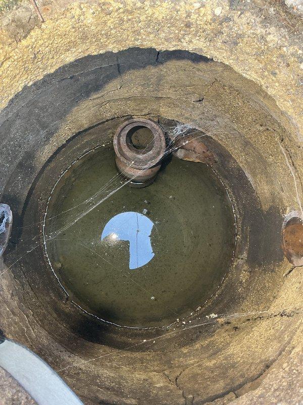 Completed comprehensive plumbing assessment of residential drainage system revealing two critical failures requiring immediate attention. Inspection identified a potentially collapsed sewer line pipe located on the property between the structure and main sewer connection, as evidenced by standing water and corroded infrastructure within the concrete access pit. Additionally, documented a broken drainage pipe in the yard leading to the catch basin, with photographic evidence showing deteriorated conditions including corroded metal fittings, stagnant water accumulation, and compromised concrete structures. Assessment also revealed under-deck piping infrastructure with PVC drainage lines and proper conduit routing. Provided detailed photographic documentation of all affected areas to support estimate preparation for necessary repairs.