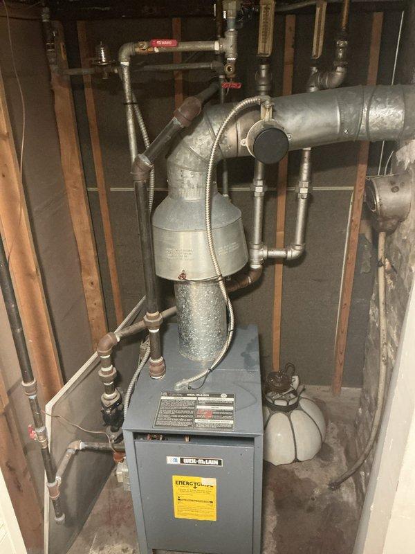 Conducted plumbing estimate for older residential property experiencing leaking pipes and compromised hydronic baseboard heating system. Assessed existing heating infrastructure including furnace/boiler unit, expansion tanks, copper supply and return lines, zone valves, and baseboard radiator units throughout living spaces. Documented visible water damage, corrosion on piping connections, and deteriorating components requiring replacement to restore system integrity and prevent further leakage.