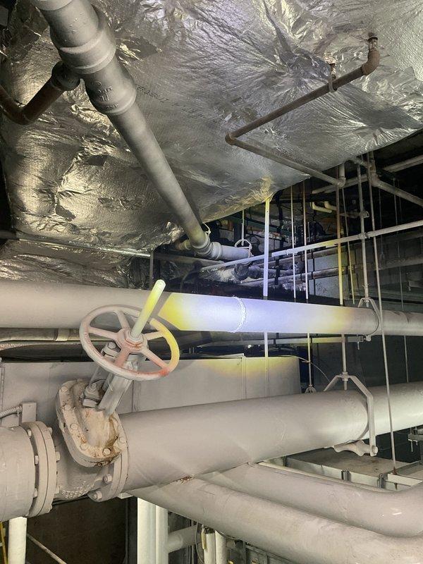 Responded to service call for drainage system not functioning properly. Upon inspection, accessed mechanical room and utility space to evaluate plumbing infrastructure and drain lines. Examined extensive network of PVC piping, ductwork, and valve assemblies throughout the mechanical space. Verified proper operation of manual shutoff valves and inspected flanged connections on large-diameter drain pipes. Cleared obstruction in drainage system, restoring proper flow and function to all fixtures. System tested and confirmed operational upon completion.