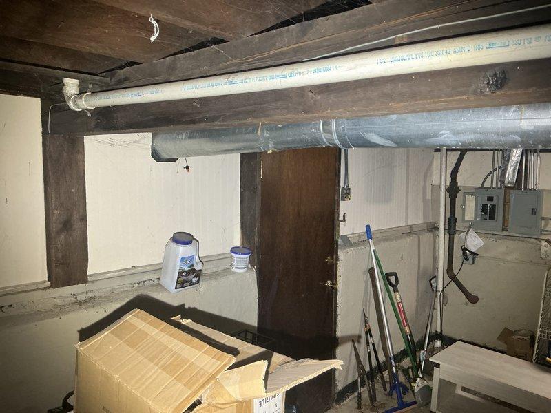Responded to customer callback regarding previously provided estimates for plumbing repairs. Customer confirmed they no longer wish to proceed with sump pump installation but remain interested in moving forward with bathroom and kitchen piping repairs. Conducted site visit to basement area to review existing conditions and verify scope of work for remaining projects. Photographed current plumbing infrastructure including visible PVC supply lines and drainage systems running through ceiling joists and along foundation walls. Confirmed estimates are still valid for the bathroom and kitchen piping work. Discussed project timeline and next steps with customer for scheduling the approved repairs.