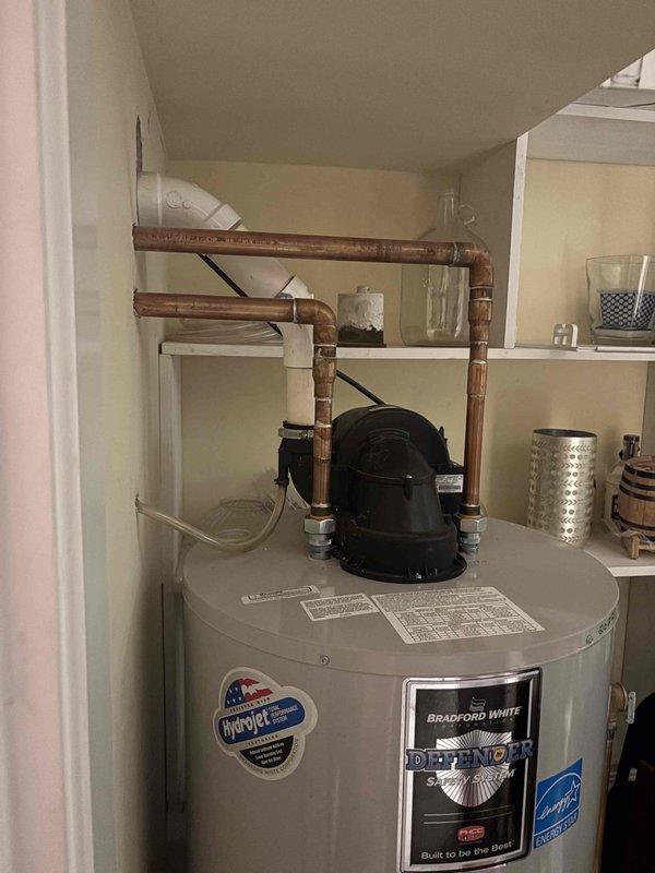 Responded to service call for leaking Bradford White RG2PV75H6N 75-gallon natural gas power-vented water heater. Upon arrival, inspected dual water heater system consisting of the failing 75-gallon unit interconnected with a 2019 Bradford White 50-gallon 40,000-BTU power-vent heater. Evaluated existing potable-water circulator pump and check valve system that provides 125 gallons of combined heated storage capacity. Documented current installation configuration including copper piping connections, isolation valves, and integration points between both units. Assessed power venting system and verified BTU ratings and gas supply lines. Photographed existing equipment, piping layout, circulator pump mounting, and connection points for replacement planning. Provided detailed assessment for complete replacement of leaking 75-gallon heater including reconnection and rebalancing of dual-heater system, evaluation of circulator and check valve replacement needs, and addition of appropriate isola