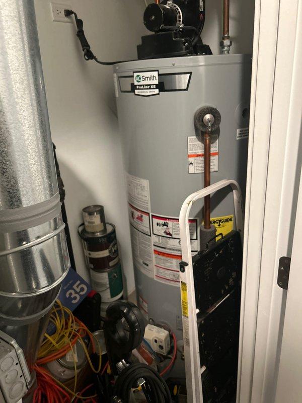 Responded to service warranty call for continuously running pump motor in 9-unit building following previous diagnostic visits. Conducted comprehensive inspection of AO Smith ProLine XE water heater system, including circulator pump assembly, expansion tank, and associated plumbing connections. Examined all copper piping, soldered joints, pressure relief valve, and PVC venting system for signs of leakage or system pressure loss. Verified proper operation of pump motor controls and electrical connections. Documented equipment condition with photographic evidence showing water heater installation, pump assembly, and mechanical room configuration to support ongoing investigation of suspected leak within building plumbing system.