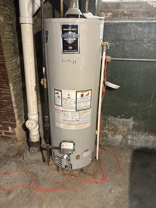 Responded to service call for gas water heater with pilot light failure. Upon arrival, inspected Honeywell gas control valve and burner assembly on residential tanked water heater unit. Verified gas supply to unit and checked pilot assembly for proper operation. Attempted pilot ignition following manufacturer's lighting procedures on control valve. Diagnosed issue with pilot ignition system and performed necessary adjustments to gas control valve settings. Successfully relit pilot light and verified flame stability. Tested main burner operation by adjusting thermostat through temperature range to confirm proper heating cycle. Inspected flue connections and verified adequate ventilation. Confirmed water heater returned to normal operation with stable pilot flame and responsive burner ignition. Documented equipment condition with photographs showing gas control valve assembly and overall unit installation for service records.
