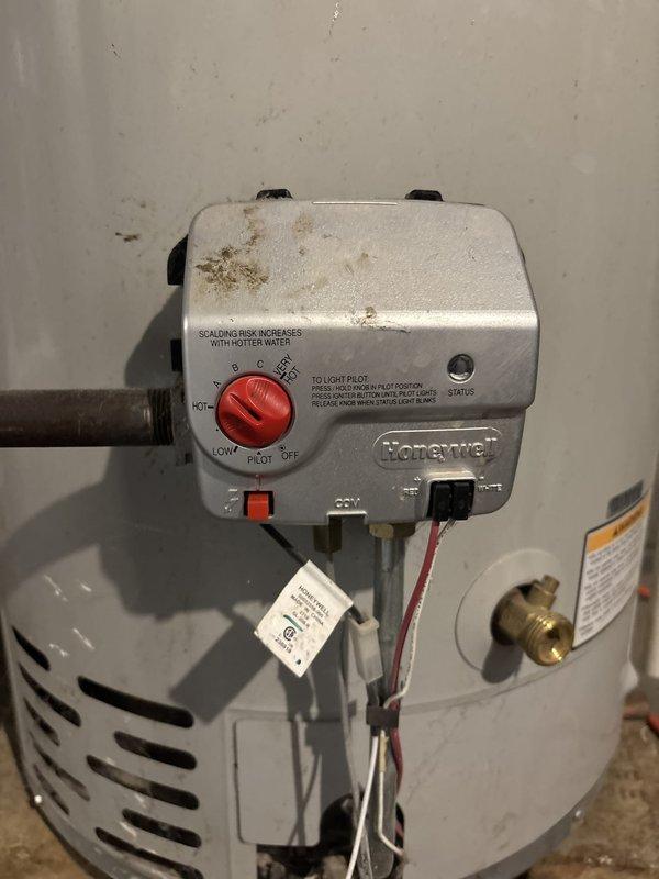 Responded to service call for gas water heater with pilot light failure. Upon arrival, inspected Honeywell gas control valve and burner assembly on residential tanked water heater unit. Verified gas supply to unit and checked pilot assembly for proper operation. Attempted pilot ignition following manufacturer's lighting procedures on control valve. Diagnosed issue with pilot ignition system and performed necessary adjustments to gas control valve settings. Successfully relit pilot light and verified flame stability. Tested main burner operation by adjusting thermostat through temperature range to confirm proper heating cycle. Inspected flue connections and verified adequate ventilation. Confirmed water heater returned to normal operation with stable pilot flame and responsive burner ignition. Documented equipment condition with photographs showing gas control valve assembly and overall unit installation for service records.