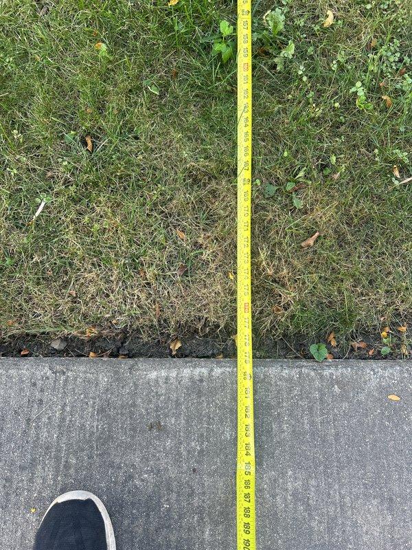 Responded to service call for sump pump battery backup system evaluation and replacement estimate. Performed on-site assessment of existing battery backup unit and measured discharge line routing from structure to lawn area. Documented current system configuration and exterior discharge point location for replacement specifications.