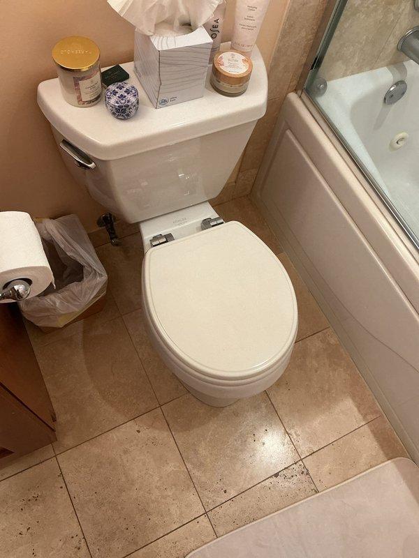 Responded to water leak investigation between two bathrooms where drywall had been previously opened by occupant. Located active drip originating from plumbing pipe in ceiling cavity above lower bathroom, with water traveling through to adjacent bathroom space. Documented existing ceiling damage, exposed framing, and temporary catch pan placement. Confirmed leak source and provided findings for repair recommendations.