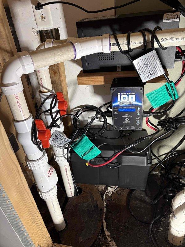 Responded to service call for non-functional ION control panel managing sump pump and ejector pump system. Upon inspection, determined that backup battery had failed, rendering the Take Control Ion Remote monitoring system inoperative. Assessed the dual-pump configuration with radon mitigation integration, noting the system included both sump and ejector pumps with dedicated control valves. Replaced failed battery and restored power to the ION control panel, verifying proper operation of display and monitoring functions. Tested communication between control unit and pump systems to ensure proper functionality. Confirmed both pumps responded appropriately to control signals and that all electrical connections were secure and properly terminated. System returned to full operational status with monitoring and control capabilities restored.