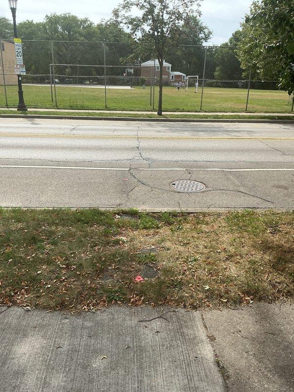 Performed sewer line camera inspection on ranch house to investigate suspected line break near street. Customer reported no current backups but wanted to verify line integrity. Accessed main sewer line through exterior cleanout and conducted video inspection from property toward street connection. Camera inspection revealed aging concrete manhole structure with significant interior deterioration, mineral deposits, and standing water accumulation at base. Interior walls showed extensive staining patterns and moisture damage consistent with long-term use and potential infiltration issues. Documented street-side infrastructure including manhole location in roadway. Inspection confirmed presence of deteriorated concrete components requiring attention. Provided video documentation and photographic evidence of findings for customer review and future repair planning.