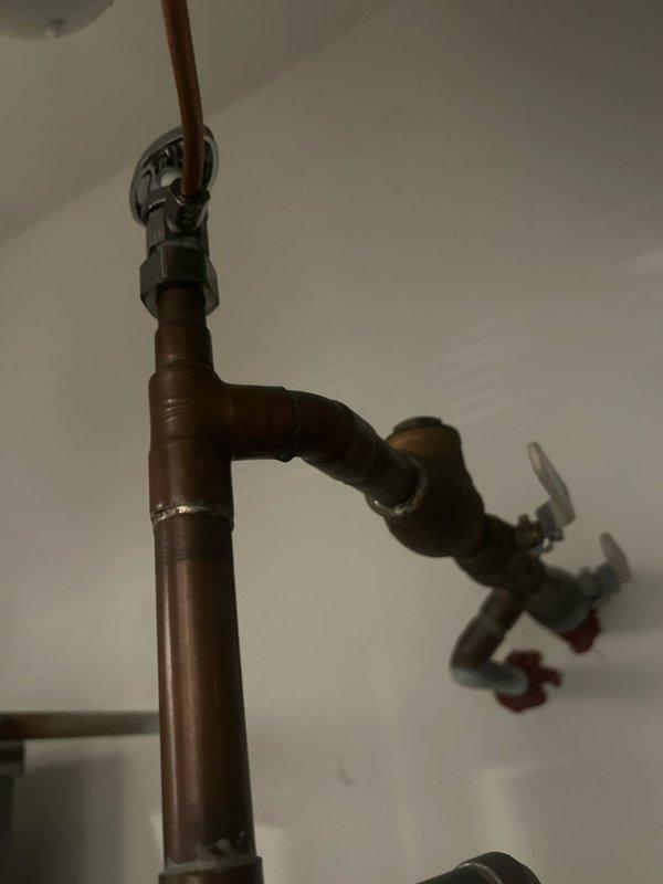 Responded to service call for continuously running pump motor in 9-unit building where previous technicians had identified suspected leak in system. Conducted thorough inspection of plumbing infrastructure, including copper supply lines, PVC drainage system, circulation pump assembly, and expansion tank. Documented existing conditions showing aged copper piping with oxidation, pump motor with metallic couplings, AMTROL expansion tank, and multiple pipe connections throughout mechanical room. Photographed system configuration to track potential leak sources and verify component conditions for ongoing warranty diagnostics.
