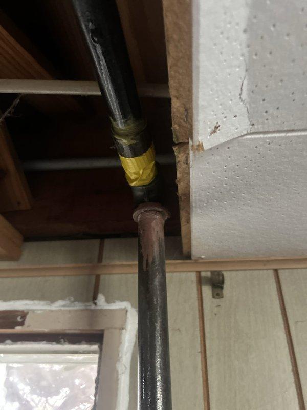Responded to gas odor complaint near kitchen stove during oven preheat operation. Conducted comprehensive gas leak inspection throughout the premises, focusing on basement utility area near water heater and dryer as previously identified by another contractor. Performed pressure testing on gas supply lines to locate and verify leak source. Inspected all gas pipe connections, fittings, and joints in the affected areas. Documented existing pipe conditions, including visible corrosion and deterioration at threaded connections on gas supply piping. Identified compromised pipe joint requiring immediate repair to eliminate gas leak hazard and restore system integrity.