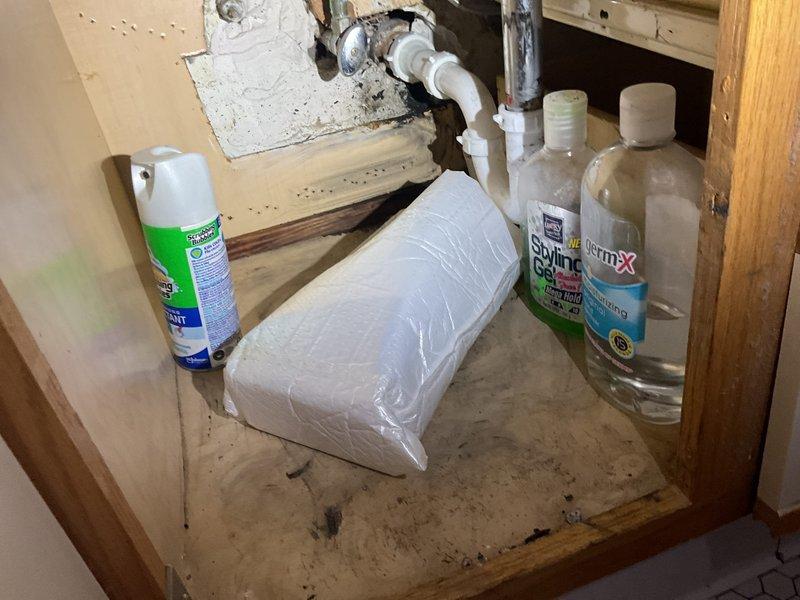 Responded to emergency service request for clogged bathroom sink and slow-draining tub in rental unit. Conducted initial assessment and documented existing plumbing conditions, including P-trap assembly, supply lines, and under-sink drainage system. Inspection revealed water damage and deterioration in cabinet area beneath sink, with visible staining on cabinet floor indicating previous moisture issues. Scheduled service appointment and added customer to priority move-up list for earlier availability if possible.