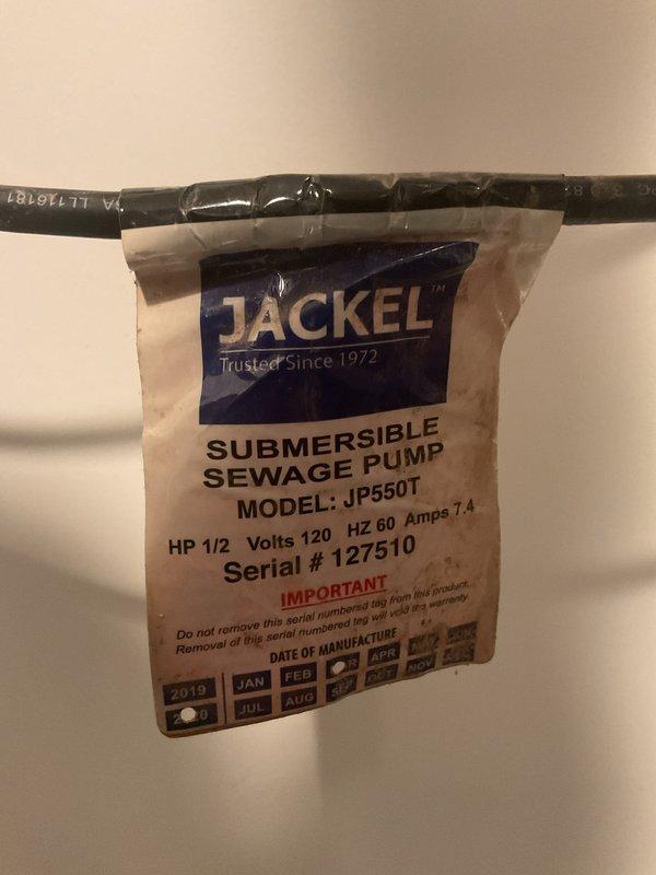 Conducted on-site evaluation of existing sump pump system to assess equipment condition and provide estimate for battery backup installation. Inspected current Jackel JP550T submersible sewage pump (1/2 HP, 120V) manufactured in January 2019, including examination of discharge piping configuration with PVC vertical runs, quiet check valve assembly, and electrical wiring routing. Documented existing plumbing installation featuring dual vertical discharge pipes with proper valve placement and cable management to determine compatibility requirements for battery backup system integration and assess whether pump replacement would be necessary based on equipment age and operational condition.