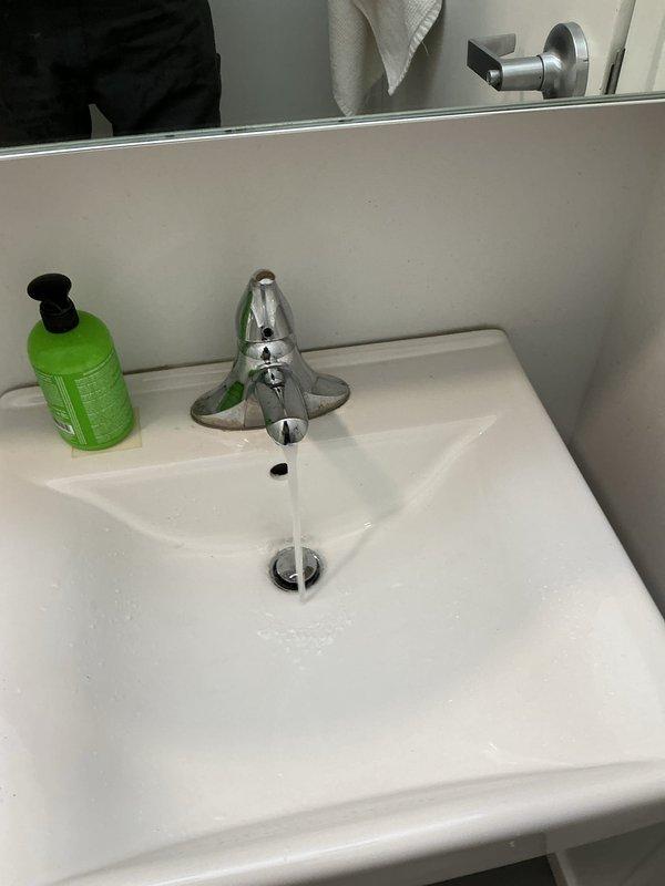 Responded to service call for clogged bathroom sink. Upon arrival, found significant staining and mineral deposits around drain area indicating long-term drainage issues. Cleared blockage from P-trap and drain line using appropriate tools and techniques. Tested water flow after clearing obstruction; drainage restored to normal function. Sink now draining properly with no standing water or slow flow issues.