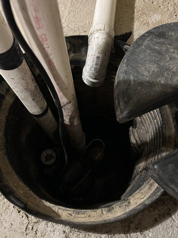 Responded to service call for sump pump discharge issue causing excessive moisture and soft ground conditions in exterior garden area. Upon inspection, identified improper drainage routing with discharge pipes releasing water directly into landscaped area rather than appropriate drainage point. Examined sump basin and discovered debris accumulation within piping system causing partial blockage and affecting flow efficiency. Cleared obstruction from affected pipe section and realigned discharge piping to redirect water flow away from garden area to prevent future soil saturation. Assessed overall sump pump operation and verified proper function of pump mechanism and float switch. Provided recommendations for ongoing maintenance including periodic basin inspection and debris removal to prevent future blockages and ensure optimal system performance.