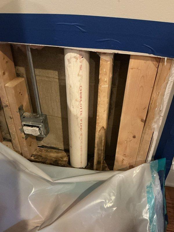 Responded to water leak detection service call and successfully located the source of the leak. Upon arrival, accessed the affected area by opening the ceiling to expose the plumbing system, revealing wooden joists, PVC piping, and electrical components. Utilized professional leak detection equipment to pinpoint the exact location of the water leak within the plumbing infrastructure. Documented the exposed area with photographs showing the Charlotte Pipe PVC system and surrounding framing. Installed protective plastic sheeting and containment barriers to prevent debris spread and protect the hardwood flooring and surrounding areas during the investigation. The leak has been successfully identified and the site is now prepared for the repair phase, with all access points opened and ready for the follow-up repair appointment.