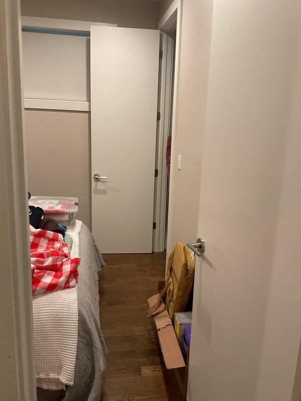 Responded to customer complaint of floor drain backing up in residential unit. Upon arrival, accessed the affected area through interior hallway near bedroom and closet space. Inspected floor drain location and assessed drainage system for blockages or obstructions causing the backup condition. Documented site conditions with photographs for service records.
