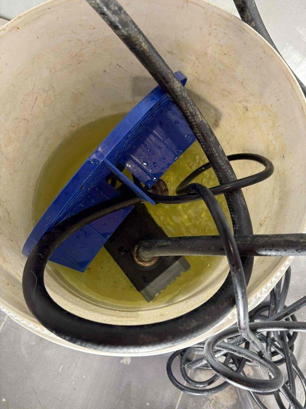 Performed annual maintenance flush on tankless water heater unit. Connected submersible pump with circulation hoses to service valves and circulated descaling solution through the heat exchanger to remove mineral buildup and sediment accumulation. Flushed system with clean water to remove all cleaning solution residue, inspected inlet filter screen, and verified proper flow rates and operational performance upon completion.