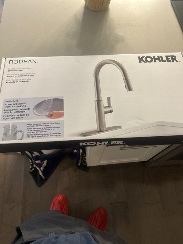 Successfully installed a Kohler Rodean single-handle pull-down kitchen faucet with high-arc spout and spray functionality in brushed stainless steel finish. The faucet was mounted to a modern double-basin composite sink with proper connections verified and tested for leaks, with water flow confirmed operational upon completion.