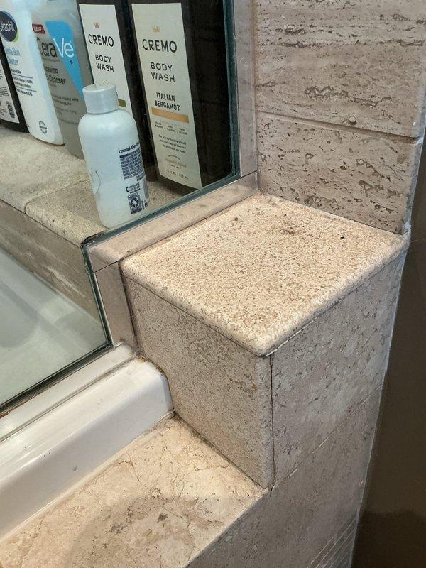 Responded to service call for shower drain leak causing water damage to ceiling below. Upon arrival, inspected bathroom with travertine tile surround and fiberglass tub enclosure. Examined shower drain assembly and surrounding areas for signs of water intrusion. Identified compromised drain seal allowing water to bypass drain connection and penetrate subfloor. Removed drain cover and tested drain line for proper flow and blockages. Disassembled drain assembly to access weep holes and gasket. Found deteriorated rubber gasket and improper seal at drain body connection. Cleaned drain opening and removed old plumber's putty and debris. Installed new drain gasket and reassembled drain assembly with proper sealant application. Torqued drain body to manufacturer specifications ensuring watertight seal. Conducted water flow test by running shower at full pressure for extended period while monitoring ceiling below for any signs of moisture penetration. Verified no active leaking present. Docume